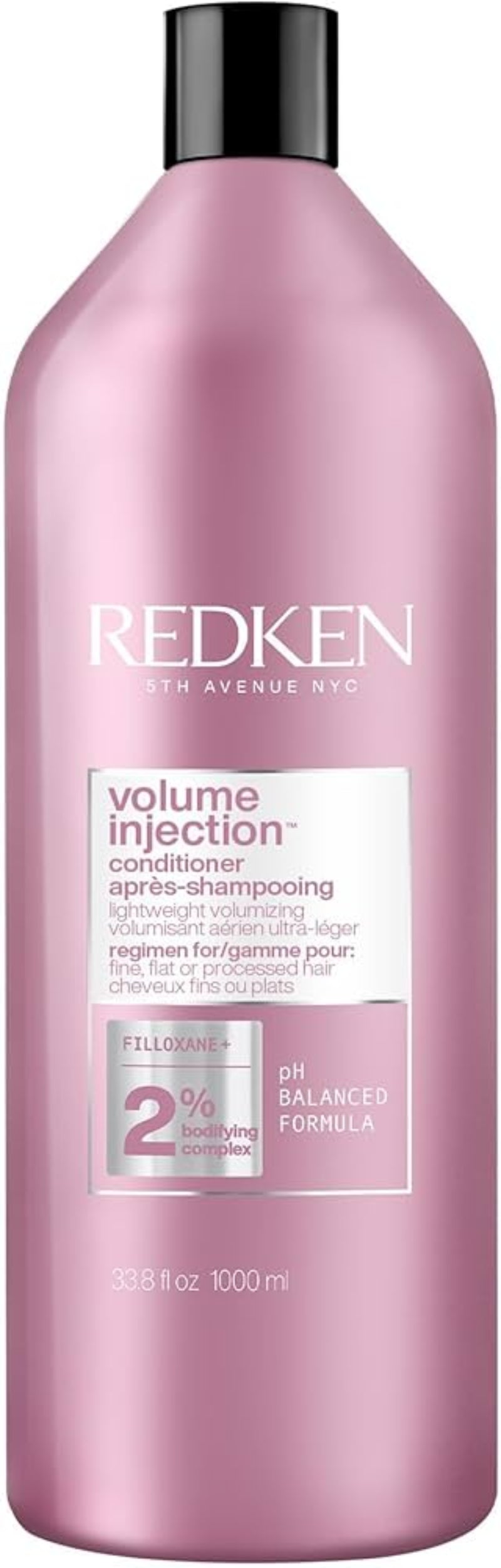Redken bottle of volume injection shampoo on a white background