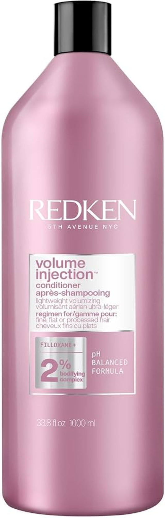 Redken bottle of volume injection shampoo on a white background